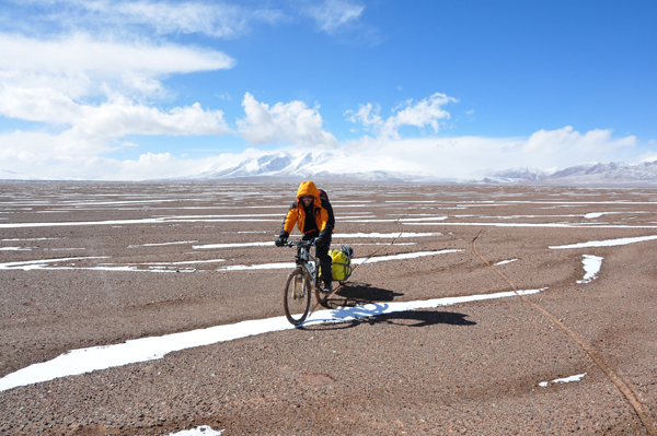 The author's friend Hamish Reid pedals across the Tibetan Plateau. Eddie Game/TNC