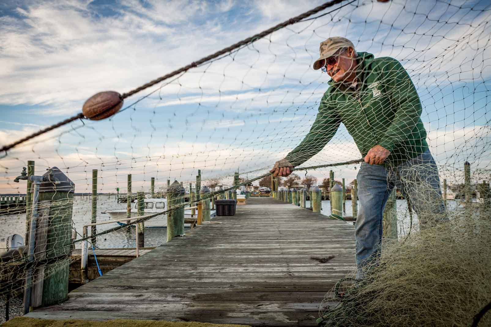 A fisherman pulls in his net and stacks it for storage at the end of the season in Chincoteague, Virginia. The mid-Atlantic region’s commercial fisheries support nearly 100,000 jobs. Photo © Jason Houston