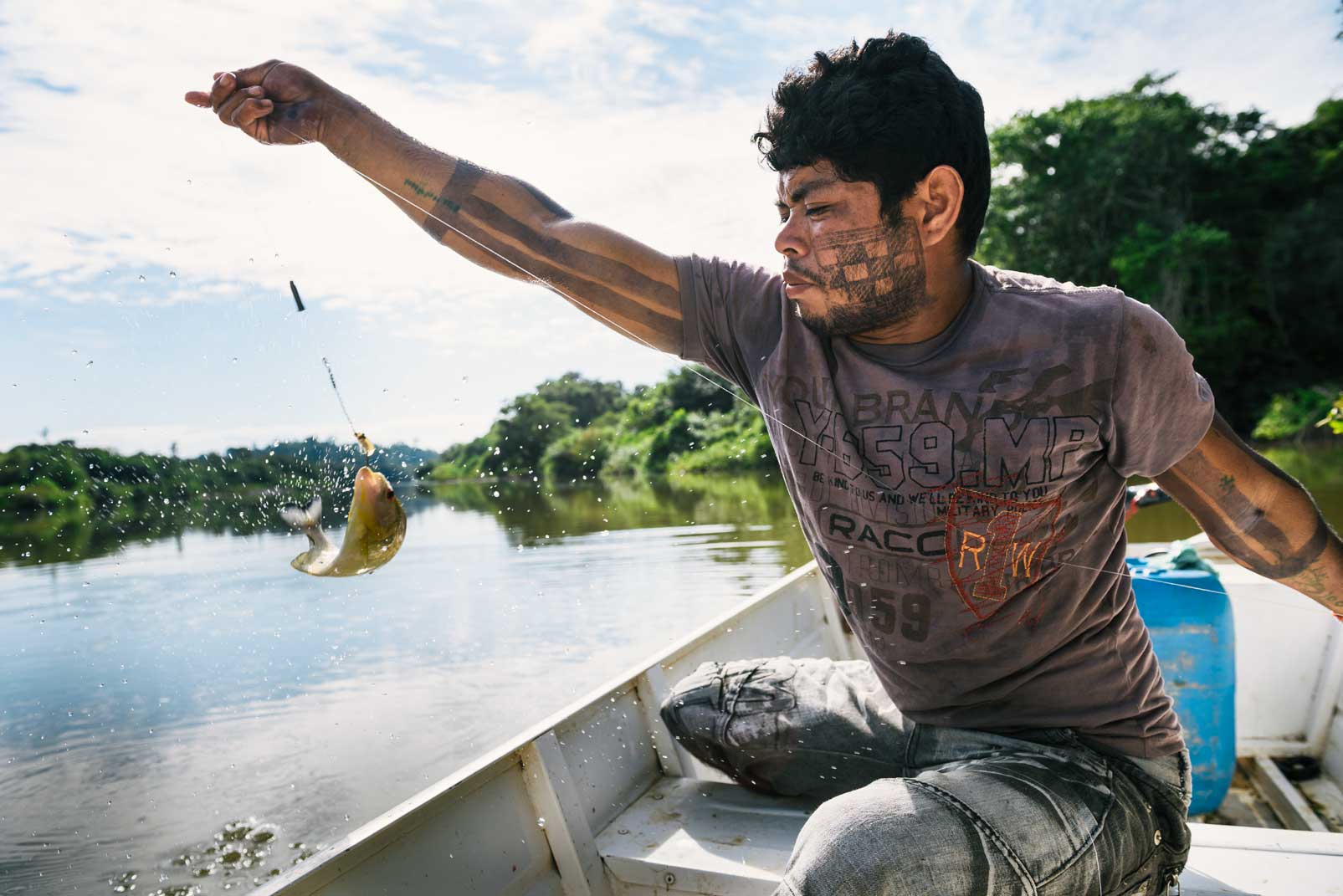 A Xikrin community member catches fish in the Rio Bacaja. The Xikrin land is one of 32 areas selected by the Brazilian government for an environment management pilot project in indigenous lands. Photo © Kevin Arnold