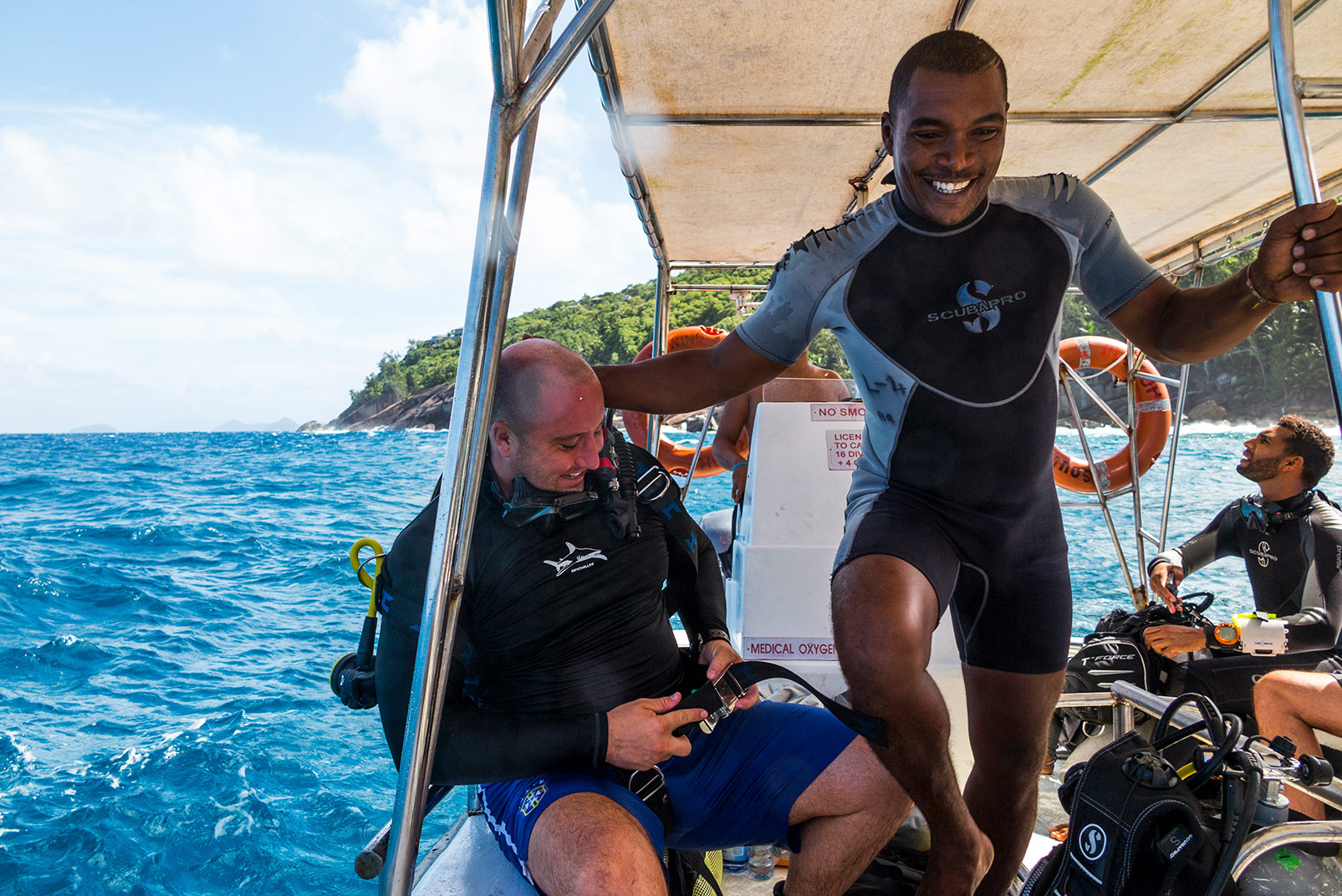 Tourism is a key part of Seychelles’ economy. Grandy Fauchette (standing) is a dive master who takes tourists from local resorts out for coastal dives. The water was too rough for Houston to dive that day in May, but typically the water is “surreal,” he says. “It’s incredibly clear and the colors are ridiculous. It’s like any of those postcards you see, and you’re like, ‘There’s no way it looks like that.’” Photo © Jason Houston