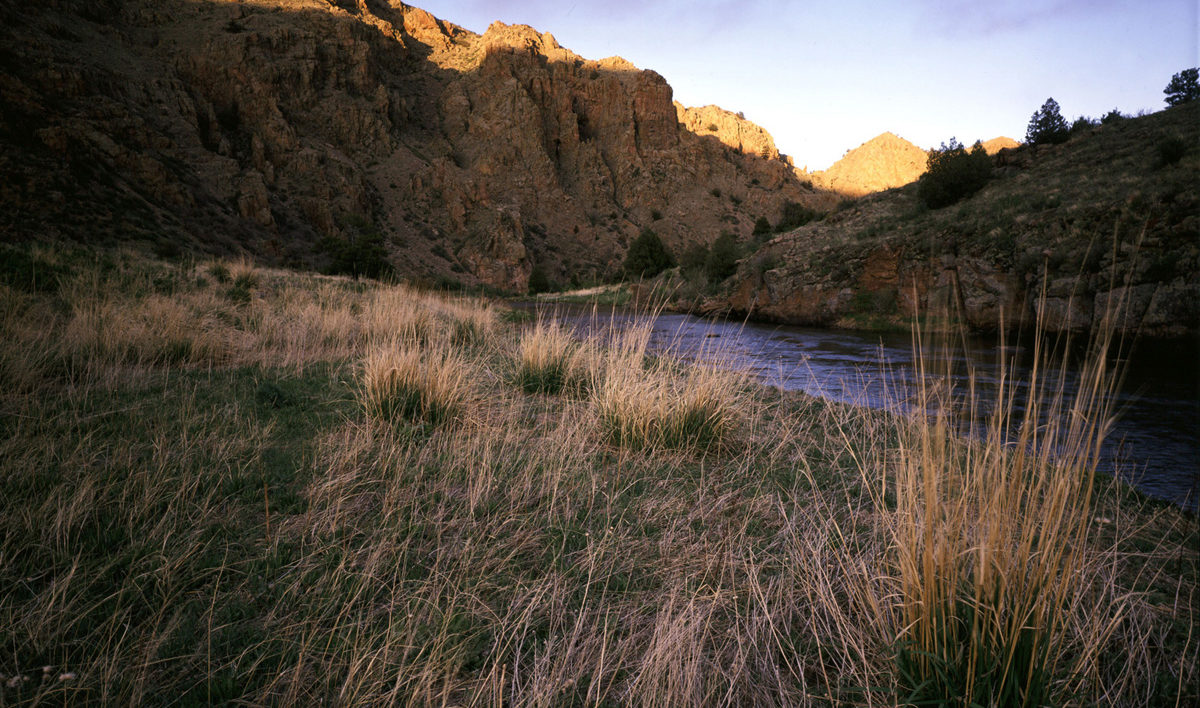 A canyon and a river at sunset.