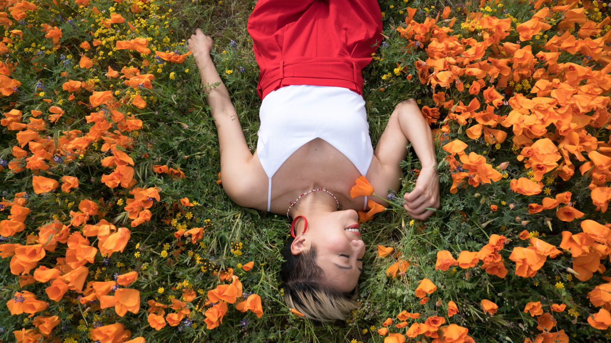 woman laying down in flowers