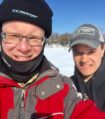 two men smiling into the cmera