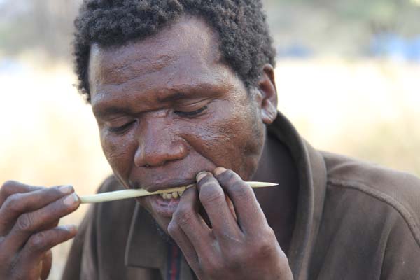 A Hadza hunter straightens his arrow. Photo: Matt Miller/TNC