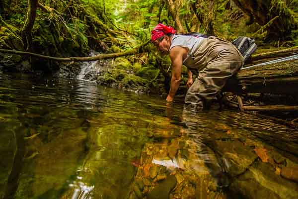 Herbert Dix assesses stream conditions. Photo: Erika Nortemann/TNC