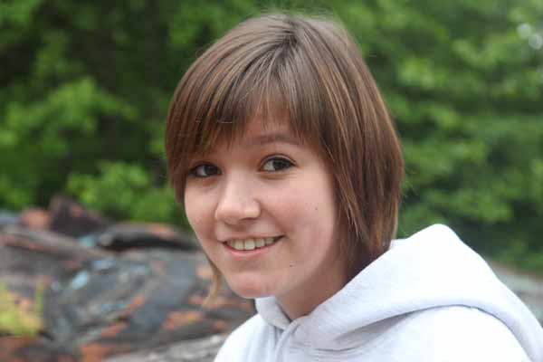 Sydney Isaacs: "This is a real privilege, a high place to be." During the past two summers, she's painted every totem pole carved in the Klawock community. Photo: Matt Miller/TNC