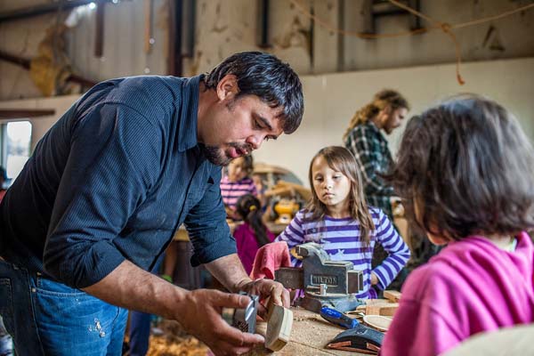 Tony Christianson demonstrates carving techniques. “We need science to show us how to restore our streams. But we also need our traditional knowledge to restore our pride,