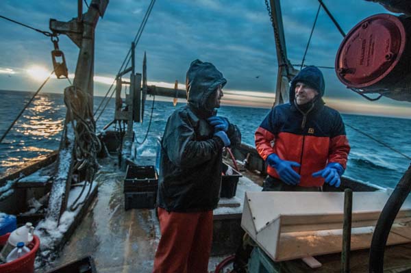 Jeff Kneebone (left), from the Mass. Division of Marine Fisheries contractor, and The Nature Conservancy's Chris McGuire, right, discuss cod findings during a research trip. Photo: John Clarke Russ