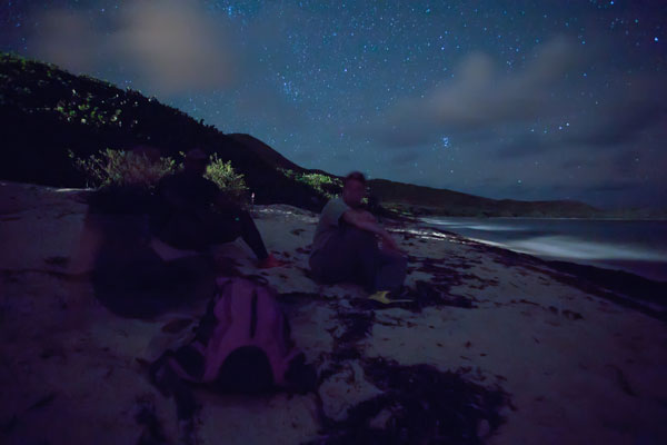 Sea turtle researchers and volunteers wait on the beach. Photo © Marjo Aho.