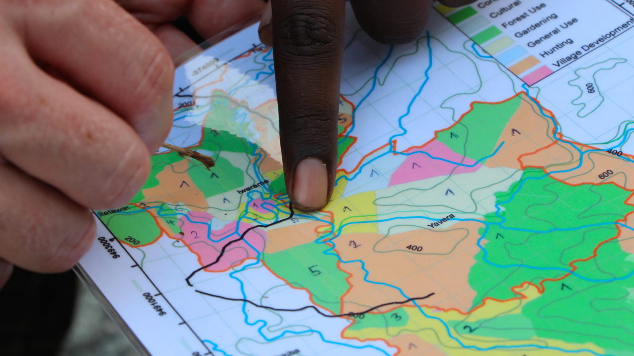 Cosmas Apelis outlines our route on a map. Photo © Justine E. Hausheer / TNC