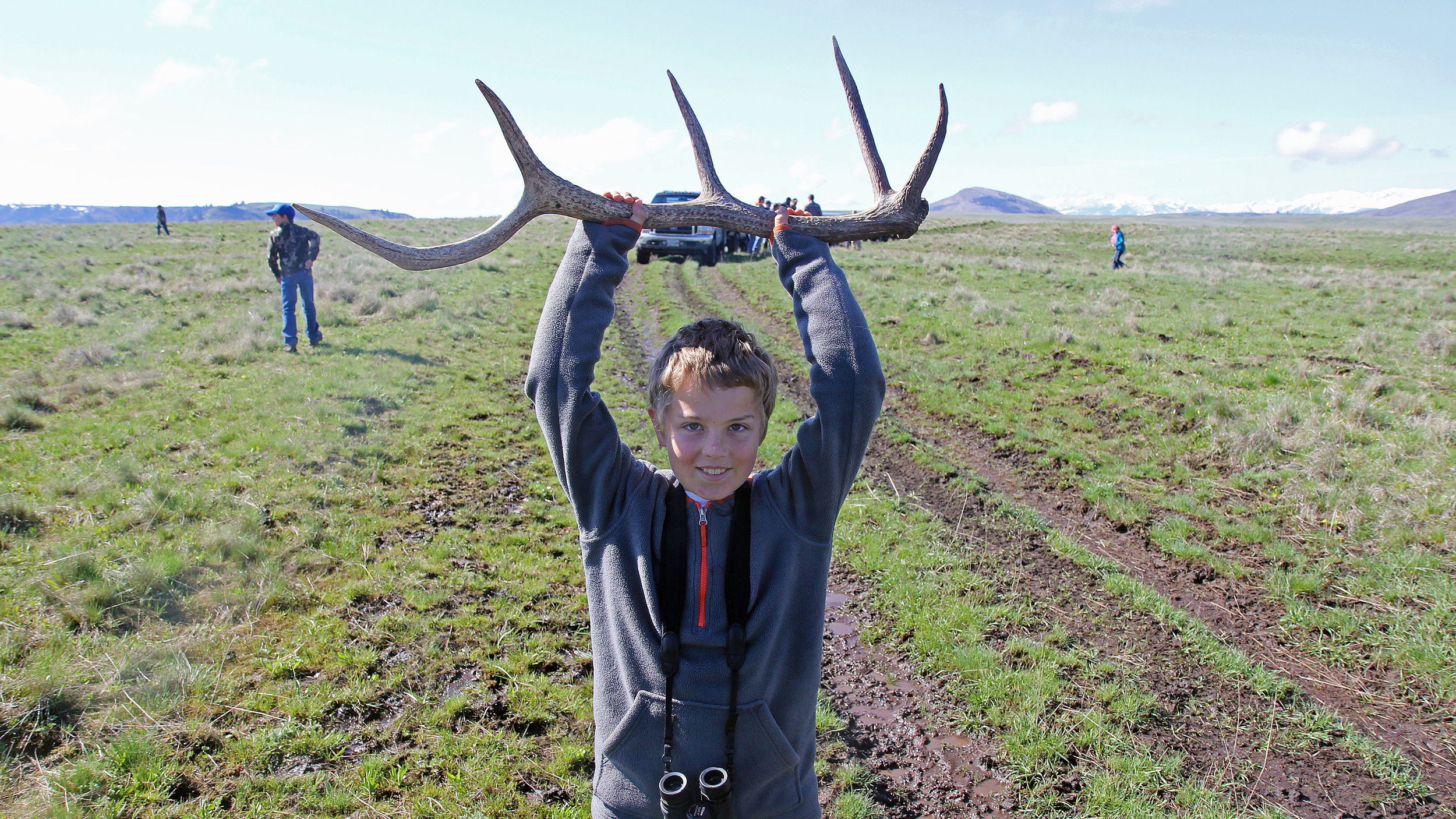Drew Beachy, son of assistant steward Mike Beachy, hoists one of the first antlers collected during the hunt. Photo © The Nature Conservancy (Matt Miller)