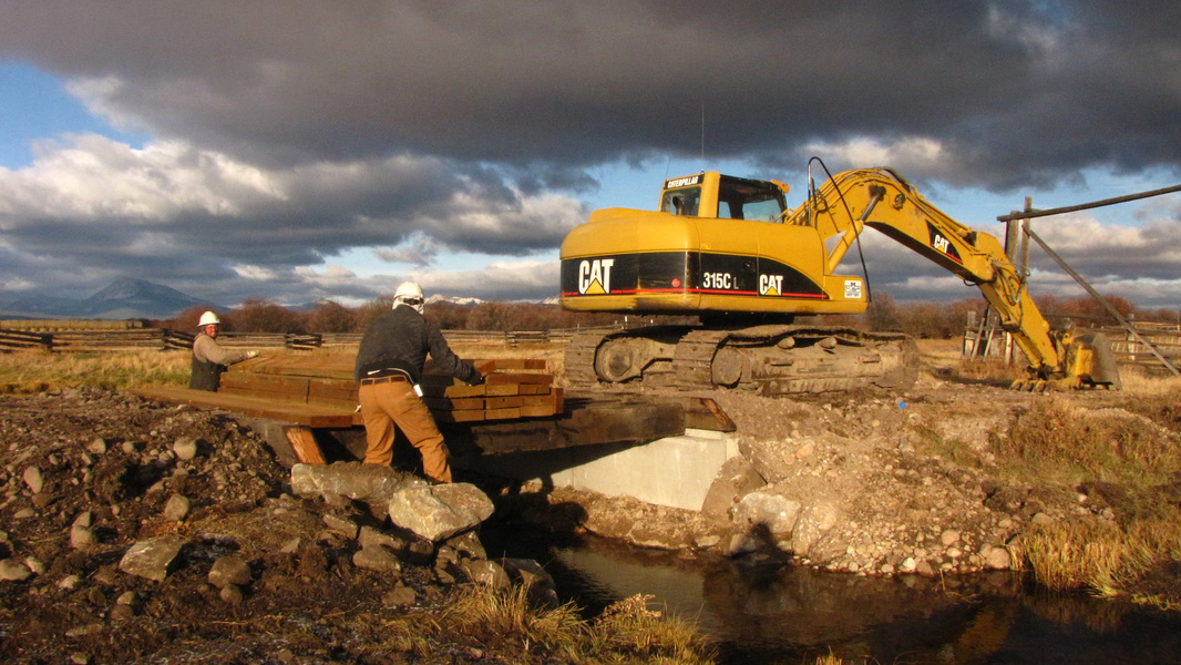 Installing a farm bridge over a tributary to the big Hole River. This bridge replaced an undersized culvert that was acting as a fish barrier. Photo © Emily Cayer FWP