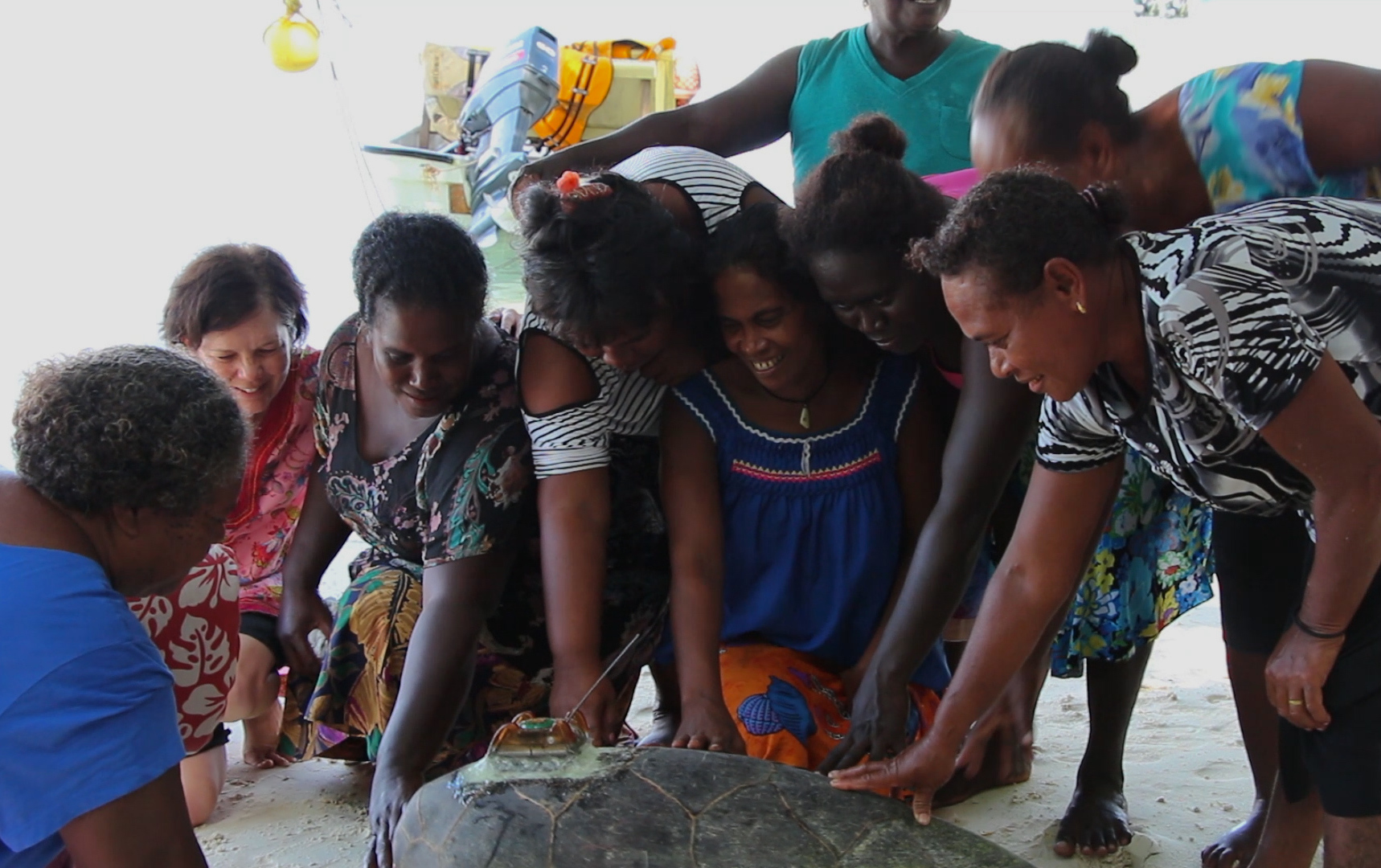 The women say farewell to the turtle named Mama KAWAKI in their honor. Photo © The Nature Conservancy (Justine E. Hausheer) 
