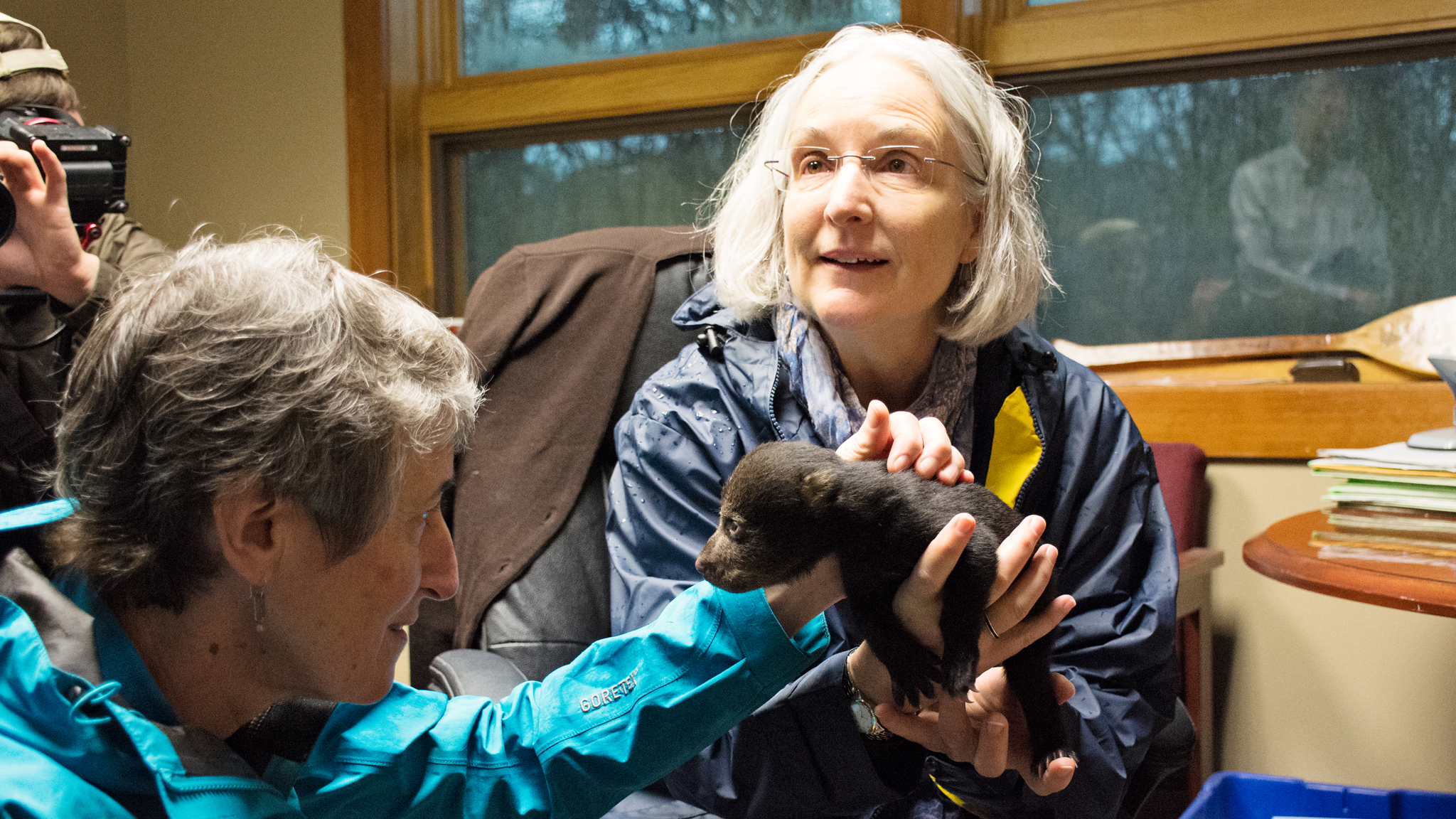 Ann Mills, Deputy Undersecretary for Natural Resources and Environment, USDA holding a cub with Sally Jewell, Secretary of the Department of Interior. Photo courtesy of NRCS