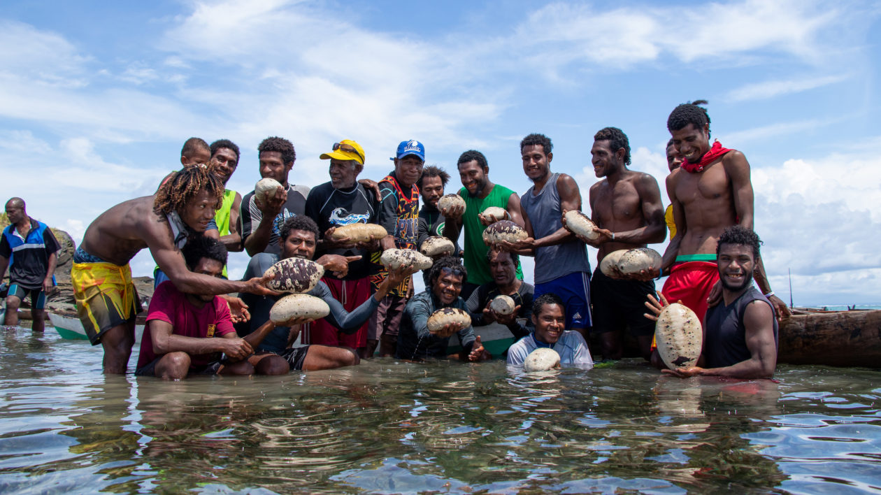 Papua children putting a fishing net off the coast of Sarmi