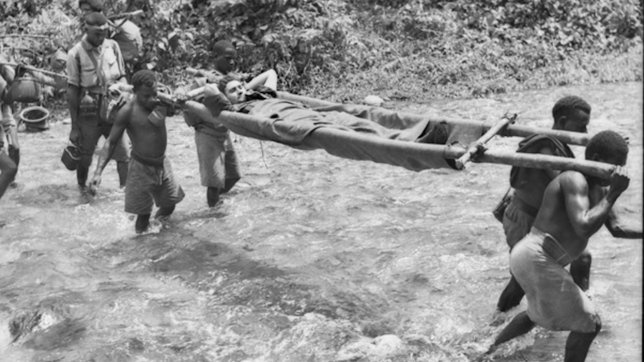 man being carried on stretcher