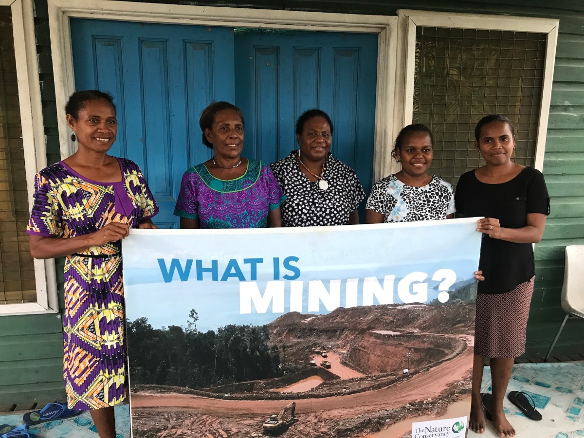 women standing with sign