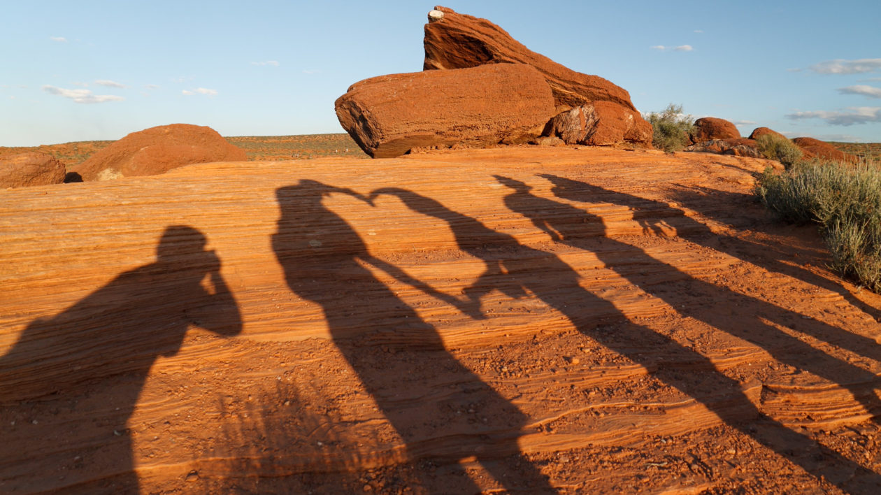 people shadows on rock