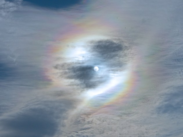 sun with rainbow and wispy clouds