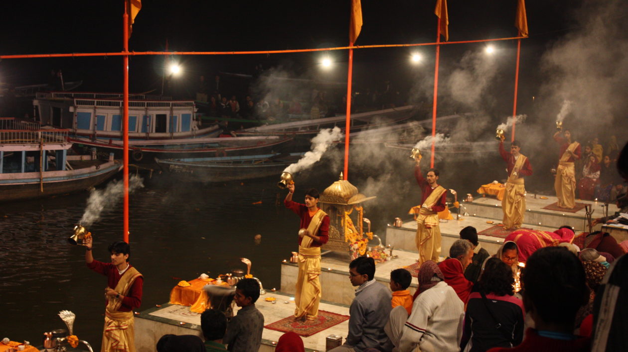 people conducting a ceremony along the river