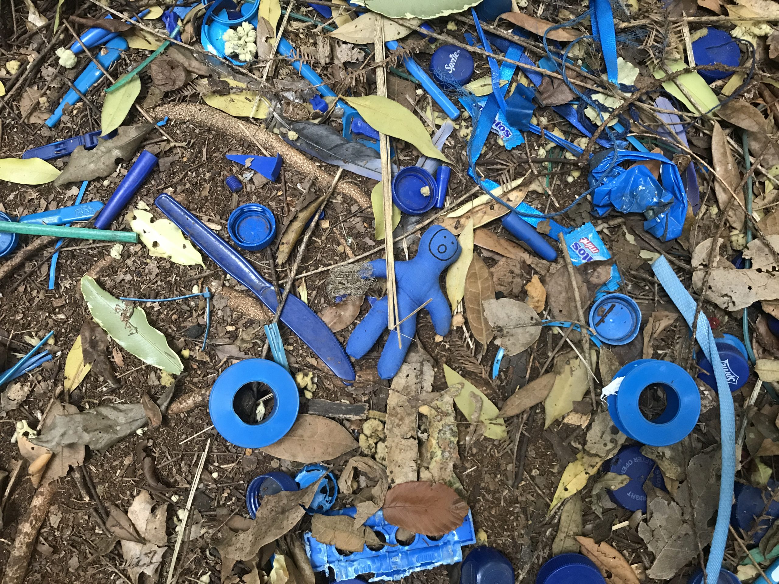 blue objects and a small toy on the gorund