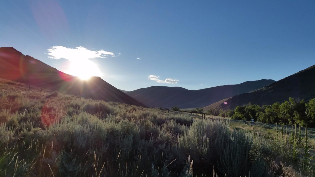 mountains with sun rising behind them