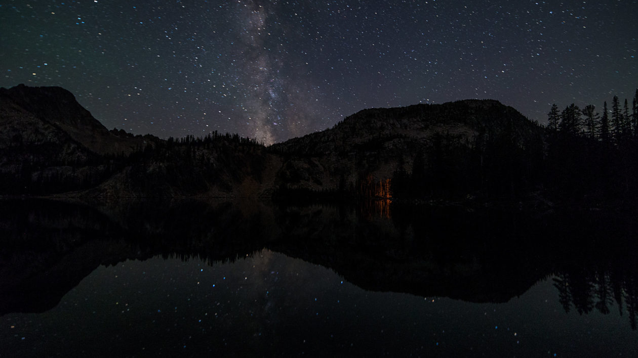 dark sky with stars and silhouette of mountains