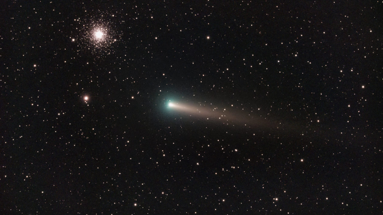 dark sky with a green streak comet