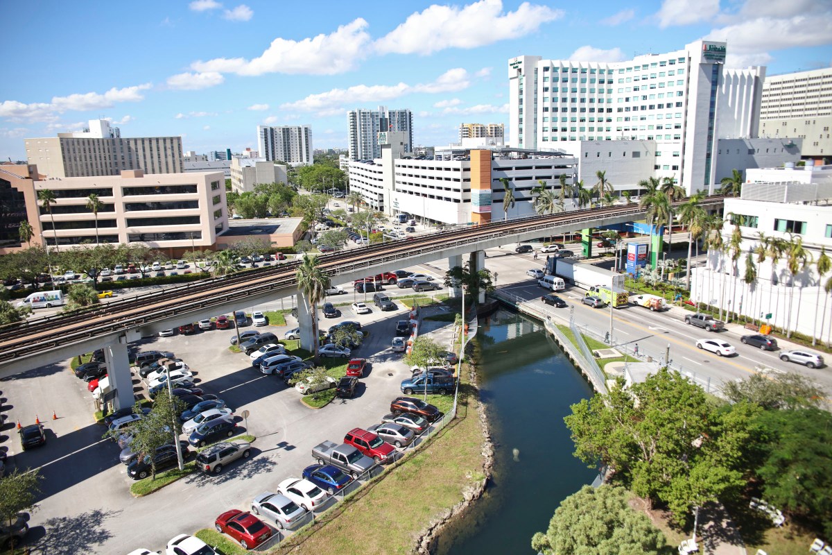 picture of urban landscape, buildings, elevated roads, cars showing typical urban expansion