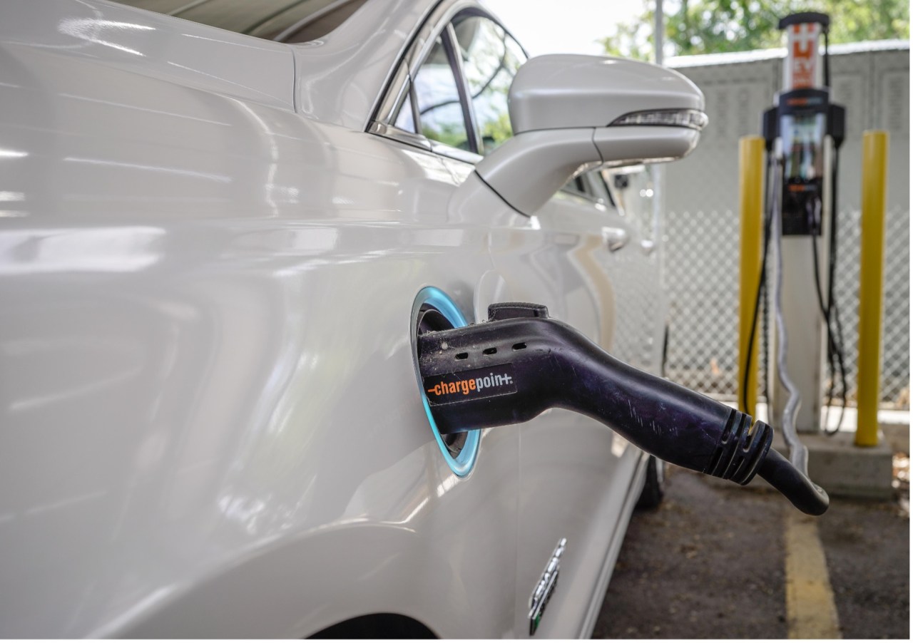 Showing an electric car plugged into a charger