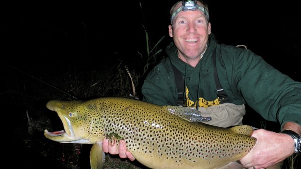The Conservancy's Central Idaho conservation manager Mark Davidson hoists a monstrous brown trout, caught at night during the "vole hatch." Mark says he could feel the large lumps of unfortunate prey in the fish's stomach. 