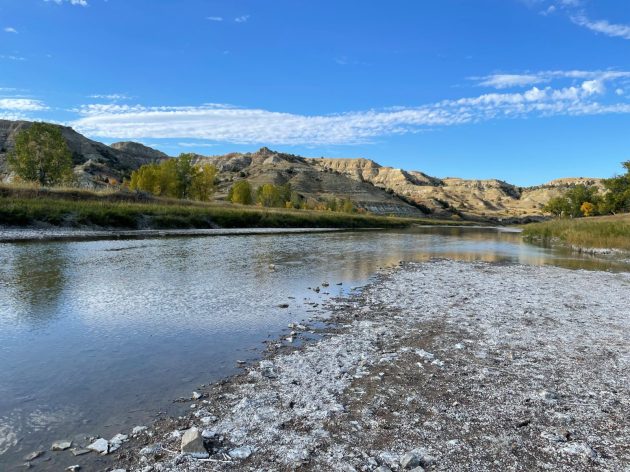 picture of a river with foothills in the background