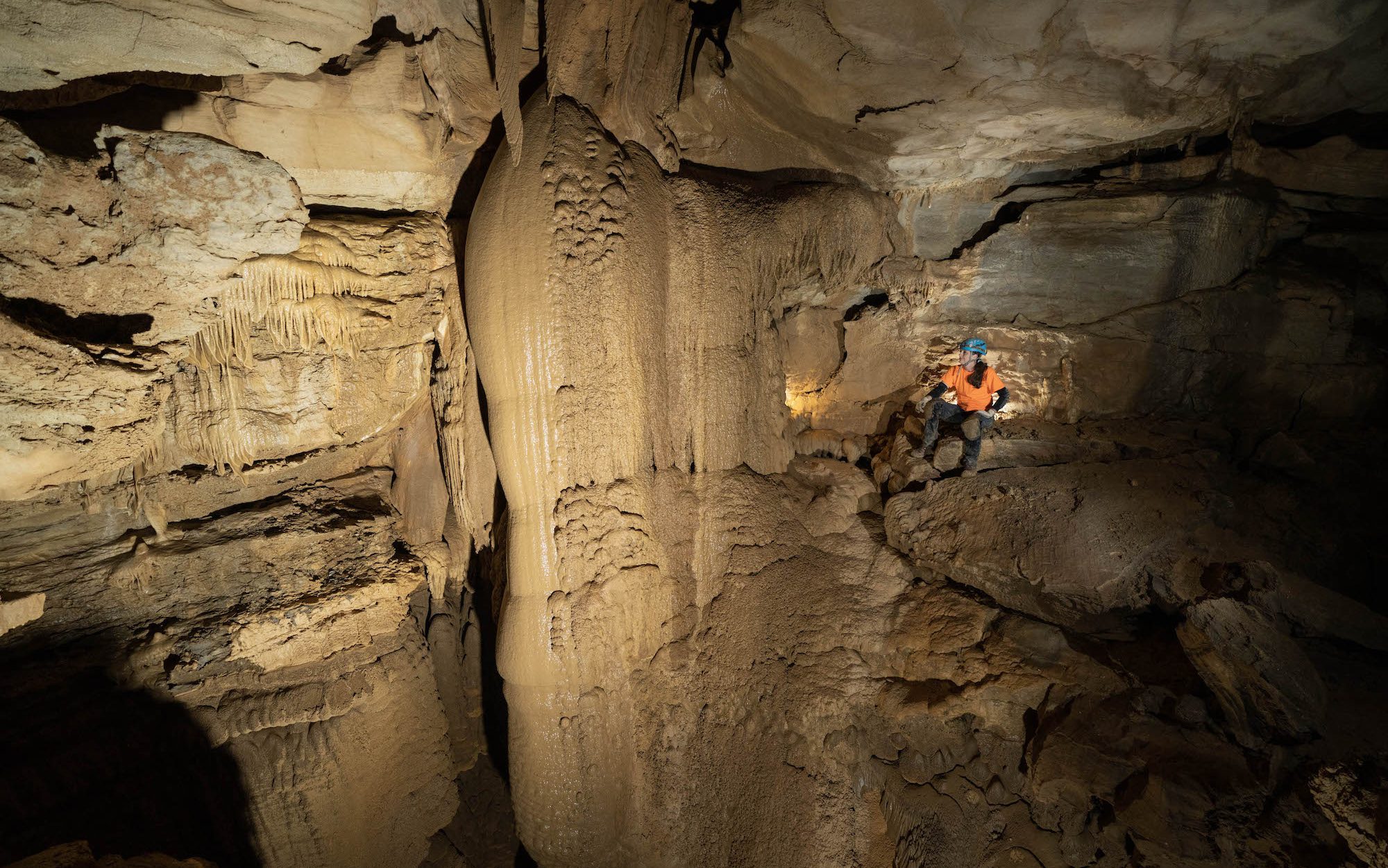 people climbing inside a cave