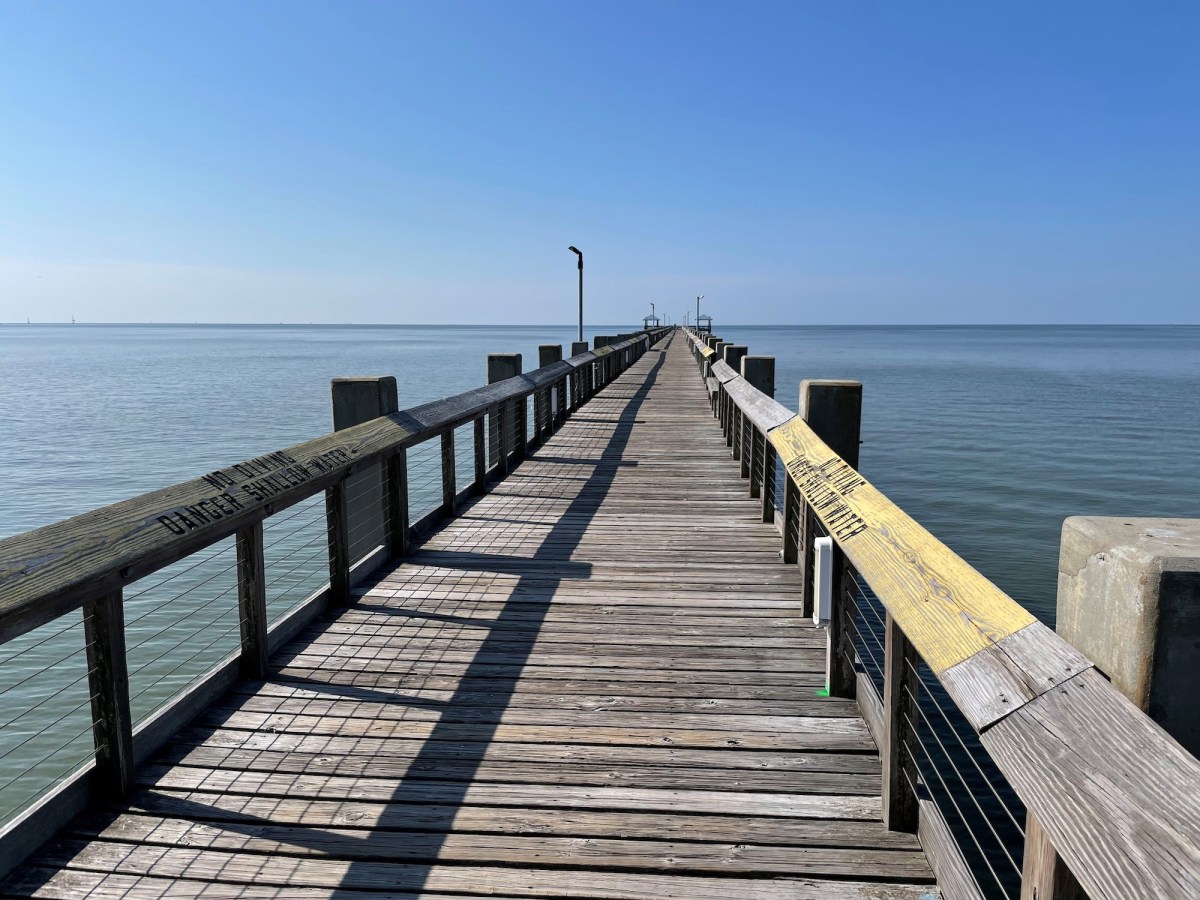 view down a pier on the ocean