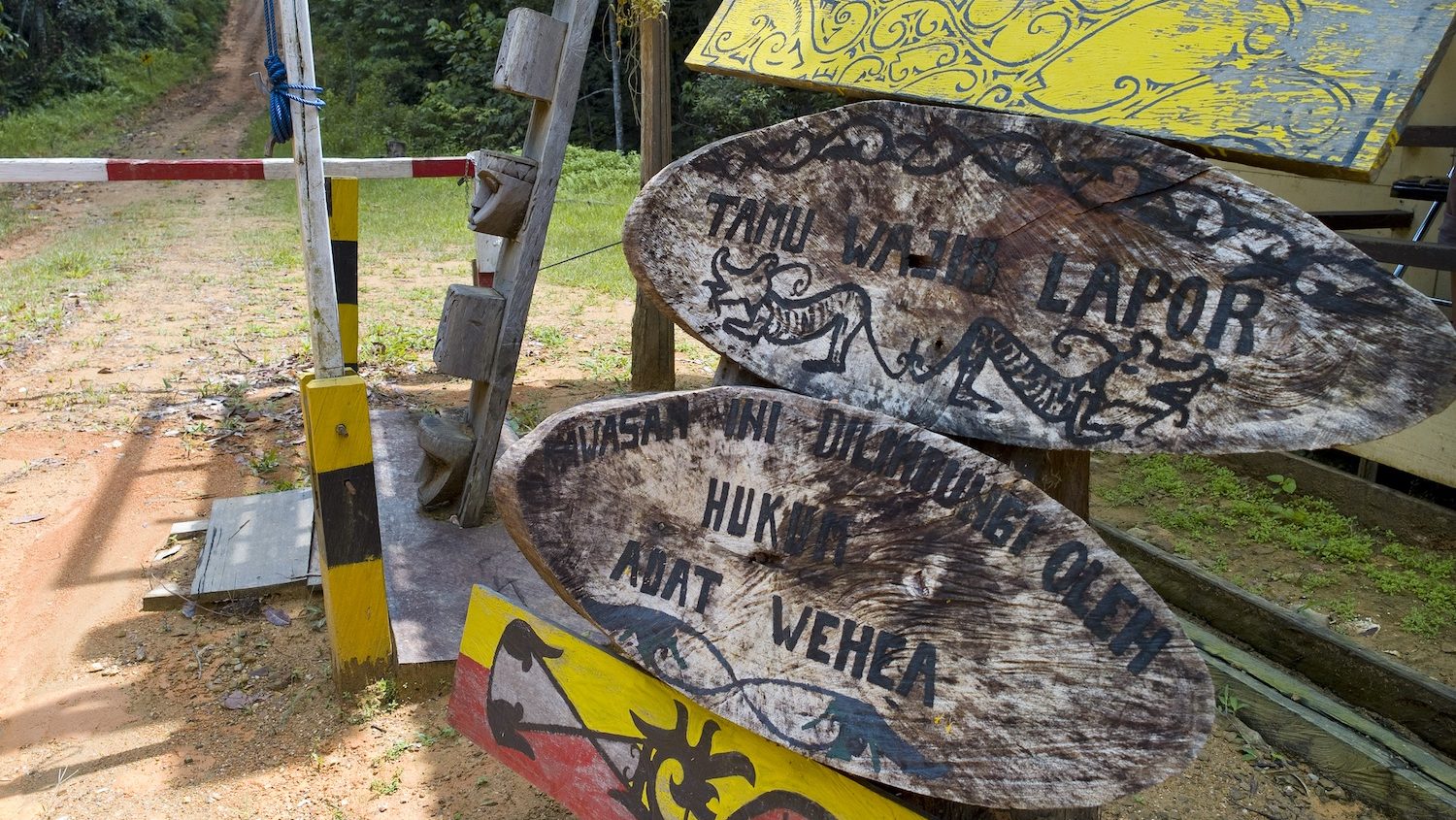 Wooden signs to the entrance of a protected area. 