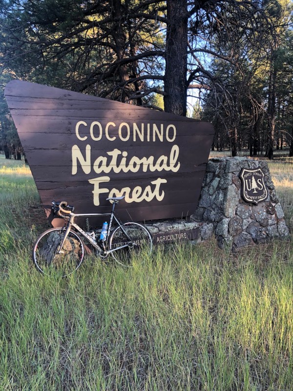 A bike leaning against a national park sign 