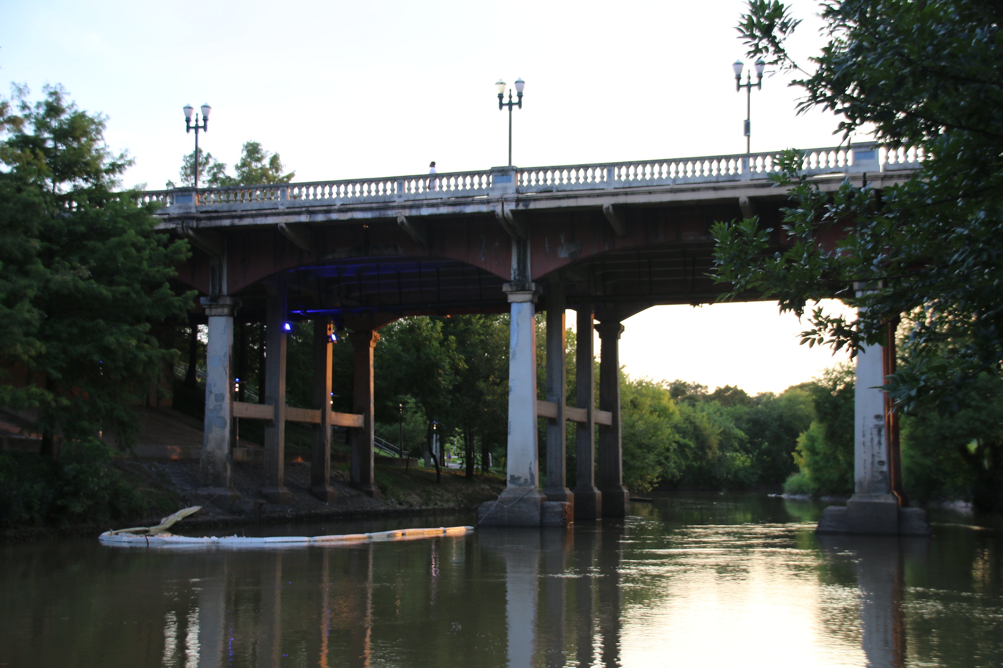 bridge span over a flat, slow-moving river