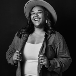 young woman in a hat, laughing