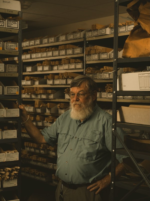 A man stands among boxes of categorized tree cores at Columbia University’s Tree Ring Lab.