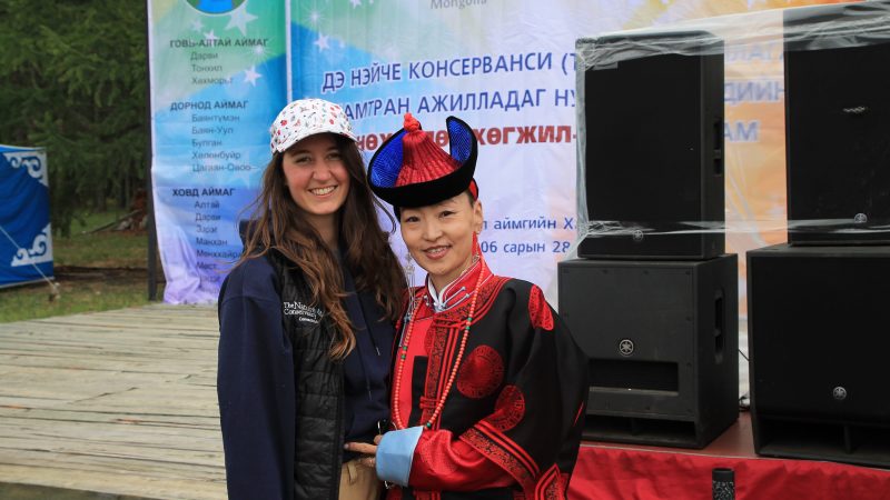 Two women, one in traditional Mongolian dress.